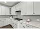 Gas range and grey backsplash in the kitchen with matching white cabinets and white countertop at 3548 Willow Green Dr, Apex, NC 27502