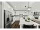 Bright kitchen featuring stainless steel appliances, stylish light fixtures, and ample counter space at 3548 Willow Green Dr, Apex, NC 27502