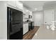 Well-lit kitchen with black appliances, white cabinets, and ample counter space for cooking and preparation at 3548 Willow Green Dr, Apex, NC 27502