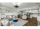 Spacious open-concept living room with hardwood floors, seamlessly connected to the kitchen and dining area at 3548 Willow Green Dr, Apex, NC 27502