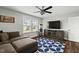 Comfortable living room featuring a ceiling fan, entertainment center, and large windows at 3548 Willow Green Dr, Apex, NC 27502