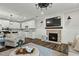 Open-concept living room with a fireplace, dark wood floors, and access to a modern white kitchen at 3548 Willow Green Dr, Apex, NC 27502