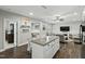 Bright, open-concept view of the home shows an island kitchen and adjoins a living room with a fireplace at 3548 Willow Green Dr, Apex, NC 27502
