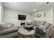 Spacious living room featuring a fireplace, soft seating, and elegant decor, perfect for relaxing and entertaining at 3548 Willow Green Dr, Apex, NC 27502