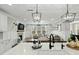 Open floor plan with designer kitchen and a view of the living room with a fireplace at 3548 Willow Green Dr, Apex, NC 27502