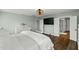 Bright bedroom with wood floors, dresser, and access to bathroom at 3548 Willow Green Dr, Apex, NC 27502