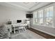 Bright office with a large window, modern desk, and comfortable seating area at 3548 Willow Green Dr, Apex, NC 27502