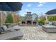 Charming outdoor patio with a stone fireplace and well designed seating and lounge areas at 3548 Willow Green Dr, Apex, NC 27502