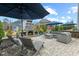 Elegant patio with outdoor fireplace, lounge chairs, and comfortable seating area for relaxing at 3548 Willow Green Dr, Apex, NC 27502