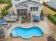 Aerial view of backyard with a kidney shaped pool, outdoor kitchen, and screened porch at 3548 Willow Green Dr, Apex, NC 27502