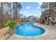 Stunning backyard pool area with stone waterfall feature and lush landscaping at 3548 Willow Green Dr, Apex, NC 27502
