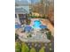 Aerial view of a lush backyard, pool, outdoor seating, a kitchen, and landscaping at 3548 Willow Green Dr, Apex, NC 27502