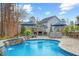Beautiful pool area with outdoor fireplace and patio seating, perfect for entertaining guests at 3548 Willow Green Dr, Apex, NC 27502