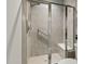 Walk-in shower with a chrome frame, white tiles and built-in seat at 3548 Willow Green Dr, Apex, NC 27502