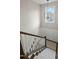 Staircase with hardwood treads, white risers, and decorative lighting at 3548 Willow Green Dr, Apex, NC 27502