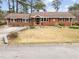 Charming brick home with well-maintained lawn and blooming flowers at 412 N Cheatham St, Franklinton, NC 27525