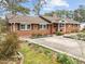 A charming brick home with a well-maintained lawn and blooming flowers at 412 N Cheatham St, Franklinton, NC 27525