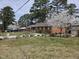Charming brick home with mature trees, flowers, flag pole, and established landscaping at 412 N Cheatham St, Franklinton, NC 27525