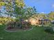 Charming brick home with mature trees, flowers, flag pole, and established landscaping at 412 N Cheatham St, Franklinton, NC 27525