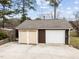 This house has a detached garage in a brown exterior with a white garage door at 412 N Cheatham St, Franklinton, NC 27525