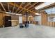 A spacious garage with an unfinished ceiling, equipped with a wood burning stove at 412 N Cheatham St, Franklinton, NC 27525