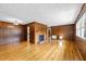 Spacious living room with hardwood floors and a cozy brick fireplace at 412 N Cheatham St, Franklinton, NC 27525