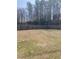 Large, grassy backyard with a wooden fence and mature trees providing privacy at 433 Falling Brook Dr, Kenly, NC 27542
