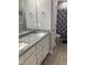 Well-lit bathroom featuring a double vanity with granite countertops and modern fixtures at 433 Falling Brook Dr, Kenly, NC 27542