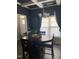 Open dining room featuring a round table illuminated by a modern chandelier and natural light at 433 Falling Brook Dr, Kenly, NC 27542