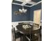 Traditional dining room featuring a dark wood table, wainscoting, and a stylish chandelier at 433 Falling Brook Dr, Kenly, NC 27542