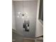 Hallway with modern light fixture and contemporary artwork leading down a staircase at 433 Falling Brook Dr, Kenly, NC 27542