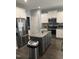 Modern kitchen with stainless steel appliances, granite countertops, and a dark wood floor at 433 Falling Brook Dr, Kenly, NC 27542