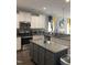 Well-lit kitchen featuring stainless steel appliances, granite countertops, and a center island at 433 Falling Brook Dr, Kenly, NC 27542