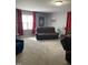 Cozy living room with comfortable seating, a large window, and soft natural light at 433 Falling Brook Dr, Kenly, NC 27542