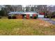 Charming brick home featuring a well-manicured front yard and a detached two car garage at 4709 Stafford Dr, Durham, NC 27705