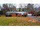 Charming brick home featuring a well-manicured front yard and a detached two car garage at 4709 Stafford Dr, Durham, NC 27705