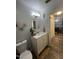 Bathroom featuring a vanity with a marble countertop, modern fixtures, and a round mirror at 5054 Avenida Del Sol Dr, Raleigh, NC 27616