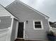 Close-up of the front door and window of this townhome, featuring neutral siding at 5054 Avenida Del Sol Dr, Raleigh, NC 27616