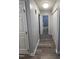 Well-lit hallway with access to a bathroom and closet space, showcasing the home's layout at 5054 Avenida Del Sol Dr, Raleigh, NC 27616