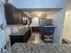 Kitchen with dark cabinets, stainless appliances, and eat-in bar at 5054 Avenida Del Sol Dr, Raleigh, NC 27616