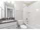 Well-lit bathroom featuring a granite countertop vanity and a tiled bathtub and shower combo at 5072 Aspen Meadow St, Raleigh, NC 27616