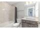 Bathroom featuring gray tile, tub, shower, and vanity with a white countertop at 5072 Aspen Meadow St, Raleigh, NC 27616