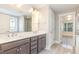Elegant bathroom featuring a double vanity, framed mirror, and access to an adjacent room at 5072 Aspen Meadow St, Raleigh, NC 27616