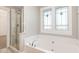 Bright bathroom showcasing a soaking tub with stylish fixtures and a separate glass shower at 5072 Aspen Meadow St, Raleigh, NC 27616