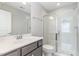 Bathroom featuring a sleek vanity with a framed mirror and a glass-enclosed shower at 5072 Aspen Meadow St, Raleigh, NC 27616