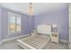 Charming bedroom adorned with a decorative chandelier, complemented by a white bed frame at 5072 Aspen Meadow St, Raleigh, NC 27616
