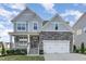Beautiful two-story home featuring stone accents, a two-car garage, and a charming front porch at 5072 Aspen Meadow St, Raleigh, NC 27616