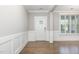 Bright foyer features hardwood floors, decorative wainscoting, and stylish front door with glass accents at 5072 Aspen Meadow St, Raleigh, NC 27616