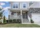 Inviting front porch with stone accents, white railings, and well-maintained landscaping at 5072 Aspen Meadow St, Raleigh, NC 27616