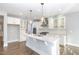 Bright kitchen with white cabinets, stainless steel appliances, and a granite island at 5072 Aspen Meadow St, Raleigh, NC 27616